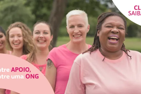 Women smiling dressed in pink for Breast Cancer Awareness Month
