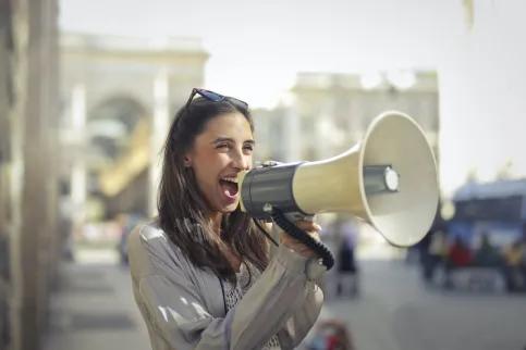 Women talking through a megaphone