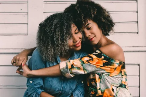 Two Black women embracing