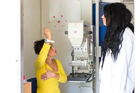 Doctor and patient at the Hellenic Cancer Society demonstrating self-exam