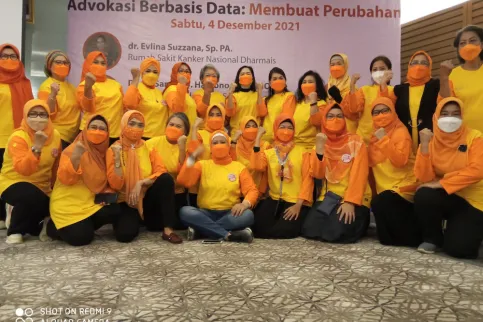 Participants at a workshop organised by the Indonesian Cancer Information and Support Center Association (CISC), dressed in yellow and orange colours and wearing masks