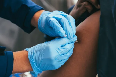 Women receiving a vaccine shot