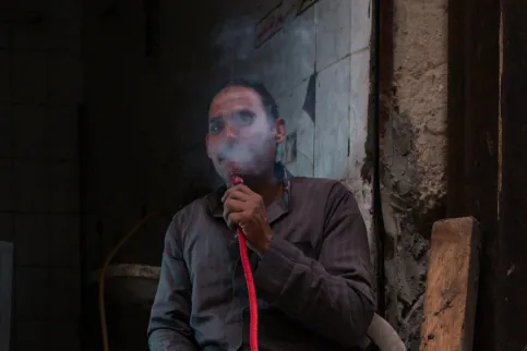 Middle Eastern man smoking a hookah
