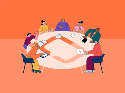 People sitting around a round table adorned with UICC's logo