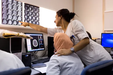 Team of doctors analyse CT scans to pinpoint exact locations of cancer cells for radiation treatment.