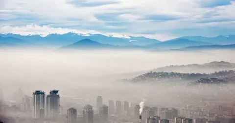 Image of city and mountains covered in smog