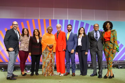 Group photo of nine men and women of diverse background