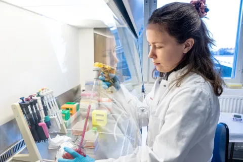 Woman in a lab in a white coat