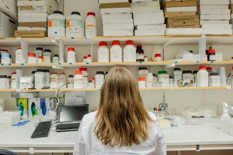 Back of a woman looking at medicines on shelves