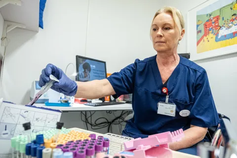 Women in blue medical clothes in a lab