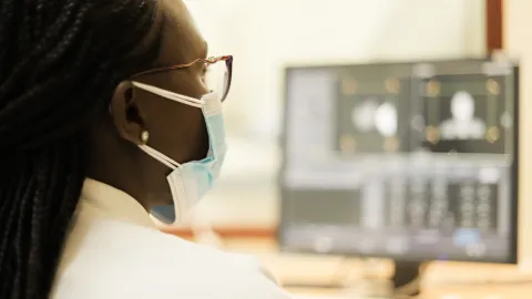 Healthcare professional reviewing medical imaging on a computer workstation at the Aga Khan University in Keyna, illustrating the use of digital technology in cancer diagnosis and treatment planning.