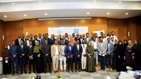 Large group of people in business attire posing for the photo