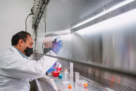 Man in white coat in a research lab 