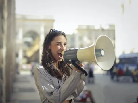 Women talking through a megaphone