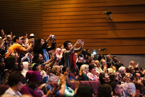 Participants take pictures at the 2018 World Cancer Congress