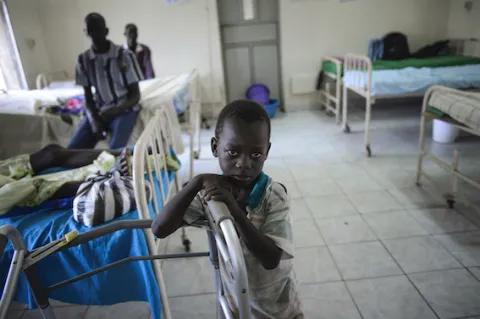 Conflict areas in Sudan have become devoid of basic health services as cancer organisations struggle to provide care. (c) Richard Juillard Child in a hospital in Sudan looks into the camera. Photo by Richard Juilliert.