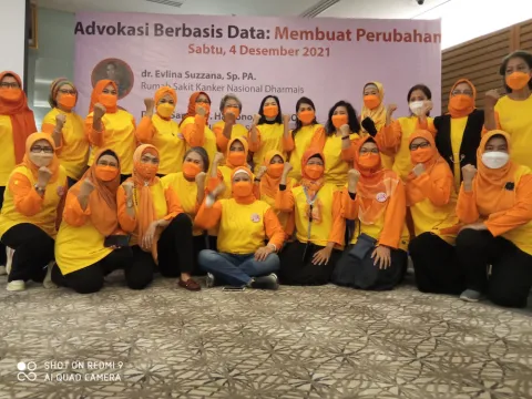 Participants at a workshop organised by the Indonesian Cancer Information and Support Center Association (CISC), dressed in yellow and orange colours and wearing masks