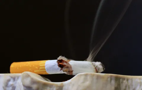 Low prices and taxes, weak regulation, sociocultural factors as well as lobbying by the tobacco industry remain the determinants of tobacco consumption that constitute a barrier to implementing effective tobacco control Broken cigarette resting on ashtray to symbolise smoking as a risk factor for many diseases including cancer and the benefits of quitting