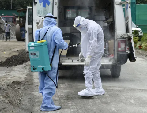Patients arrived at a makeshift COVID-19 hospital, at Khanapara Veterinary Ground, during the total lockdown imposed by the Assam Government to curb the spread of the novel coronavirus, in Guwahati, Assam, India Two medical practioners in personal protective equipment at a makeshift COVID-19 hospital in India.