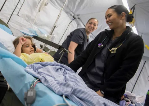Grace Romasko with a 4-year old Honduran girl in the expeditionary medical unit in Puerto Cortes, Honduras, during the US operation "Continuing Promise" in 2018. Photo by Mike DiMestico. Grace Romasko with a 4-year old Honduran girl in the expeditionary medical unit in Puerto Cortes, Honduras, during the US operation "Continuing Promise" in 2018. Photo by Mike DiMestico.