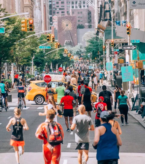 A bustling street of New York with joggers everywhere A bustling street of New York with joggers everywhere