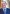 Headshot of Prof. Jeff Dunn, AO, President of UICC (2022-2024), in blue suit and tie, clasping hands in front of him