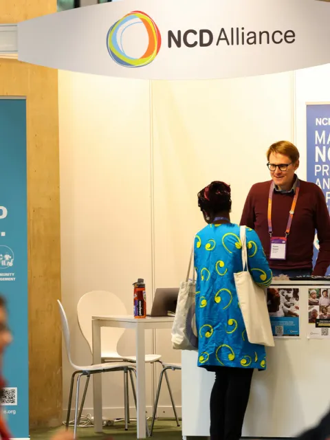 People speaking at a NCD Alliance stand