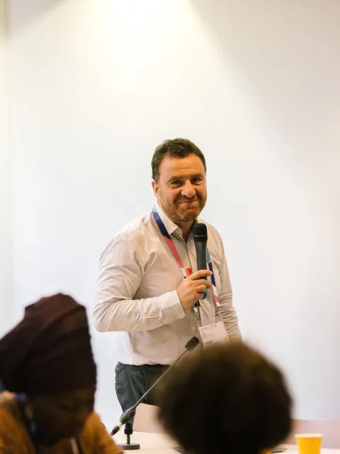 White man talking with a microphone
