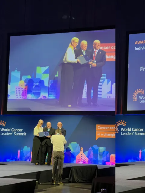 Combined podium shot of award winners being congratulated on stage