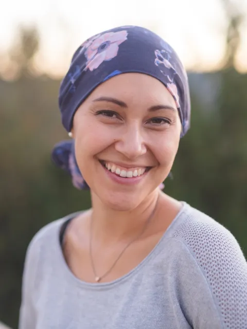 Young woman wearing a headscarf smiling to the camera