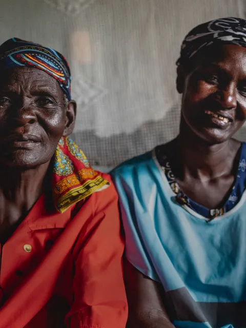 Two African women smiling into the camera, cut at chest