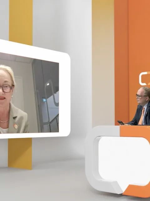 Screenshot of UICC's virtual General Assembly, with Cary Adams in a virtual studio speaking with the new UICC President Ulrika Kagstrom