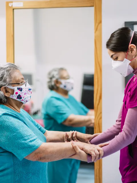 Patient and healthcare professional doing exercises