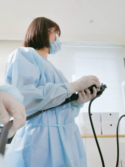 Closeup low angle view asian physician colonoscopy to patient in the clinic with nurse assistance - cancer related examinations