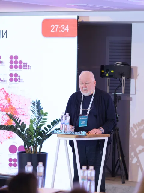 Older man speaking at a podium
