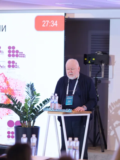 Older man speaking at a podium