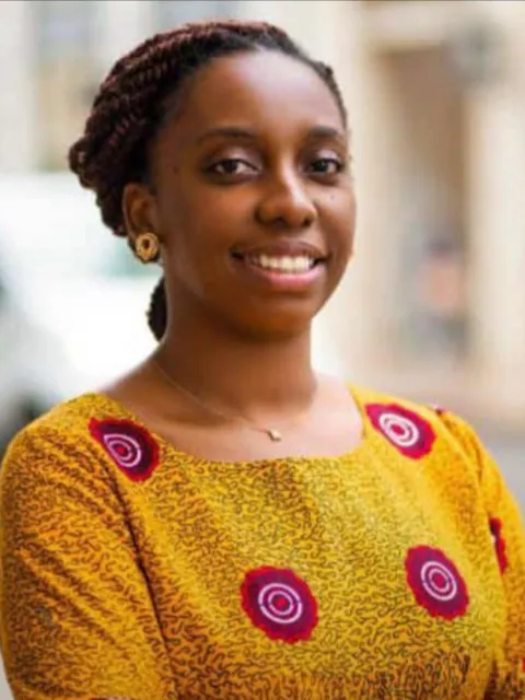 Headshot of an African woman with yellow top