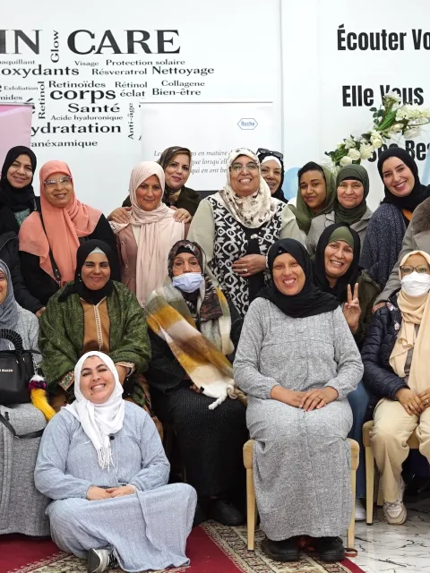 Group of Middle Eastern women smiling, part of a cancer patient organisation