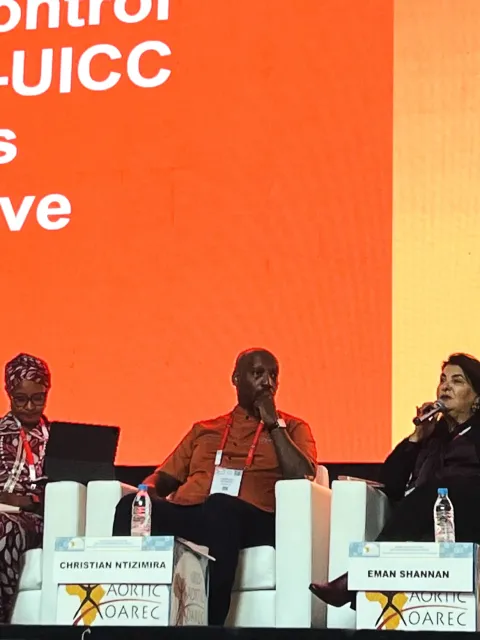 Four diverse panelists in front of a branded screen for UICC
