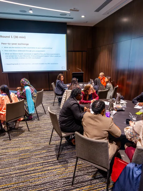 Several roundtables with diverse participants (women) at a workshop