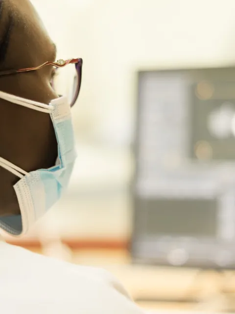 Healthcare professional reviewing medical imaging on a computer workstation at the Aga Khan University in Keyna, illustrating the use of digital technology in cancer diagnosis and treatment planning.