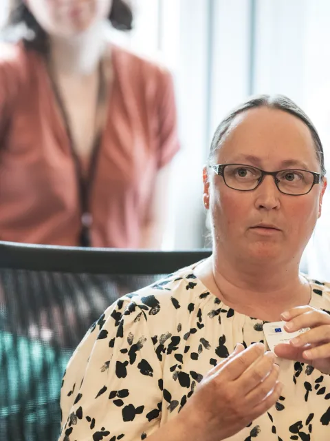 Headshot of a Scandinavian woman with glasses speaking at a conference
