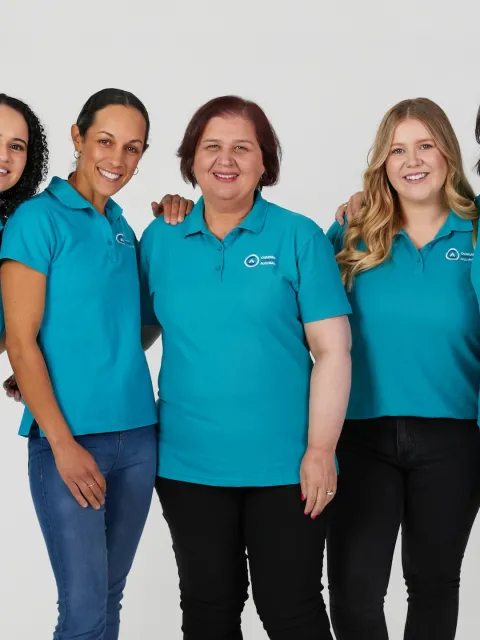 Diverse group of five women wearing turquoise branded shirts for Ovarian Cancer Australia