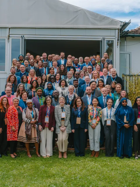 Diverse group of people standing outdoors in front of a pavillion