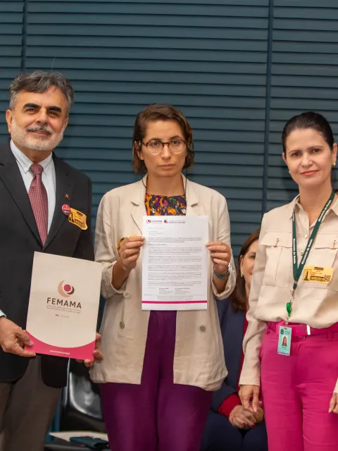 Latin American man and two women receiving a prize