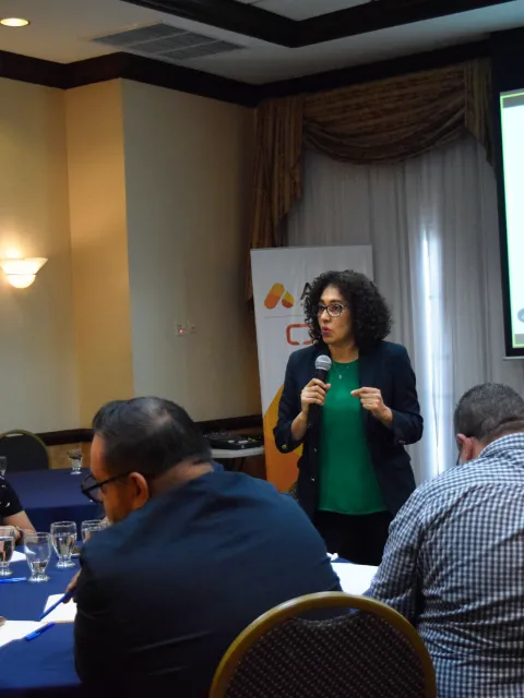 Woman speaking at an ATOM Coalition symposium
