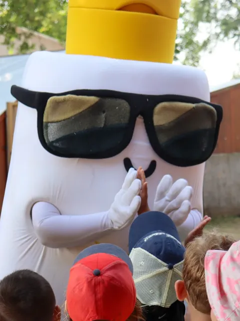 Melanoma Canada mascot in shape of sunscreen bottle
