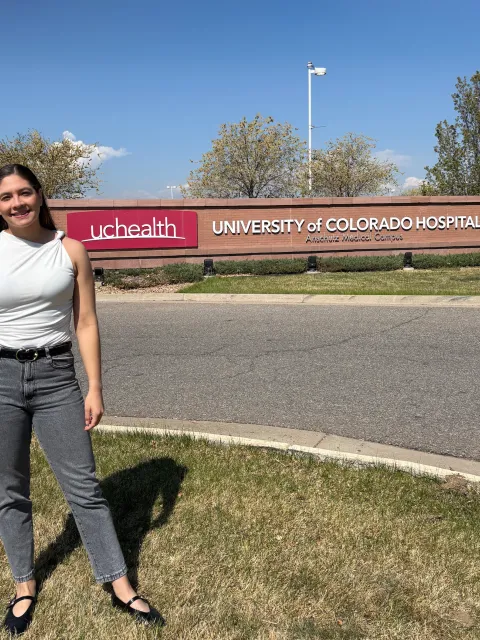 Photo of woman standing in front of University of Colorado Hospital sign