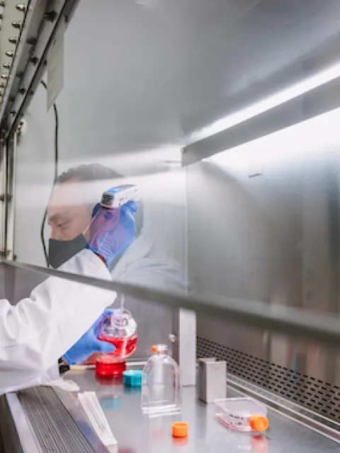 Man in white coat in a research lab 