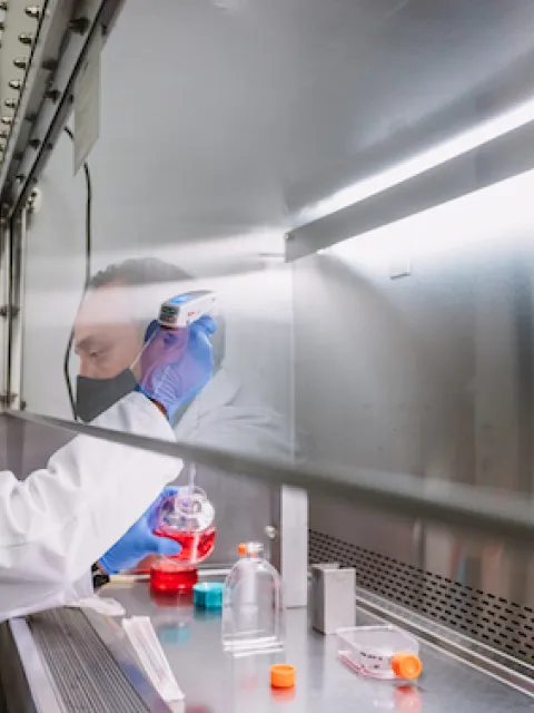 Man in white coat in a research lab 